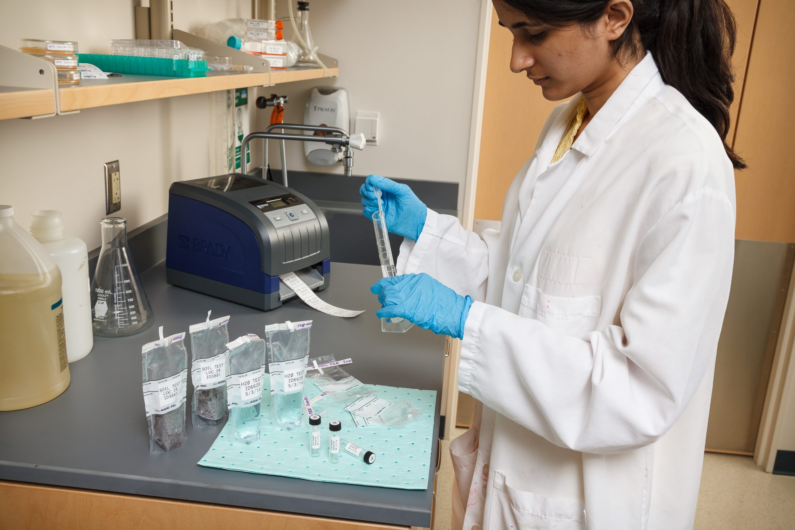 Healthcare worker using the Brady Printer i3300 to label specimens.